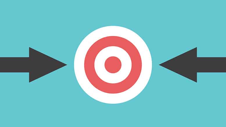 A dart in the center of a target, on an orange background